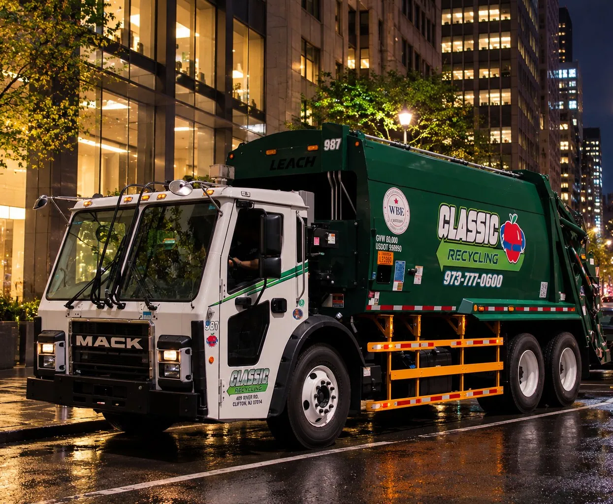 Classic Recycling truck on a wet Manhattan street at night, office towers lit behind it